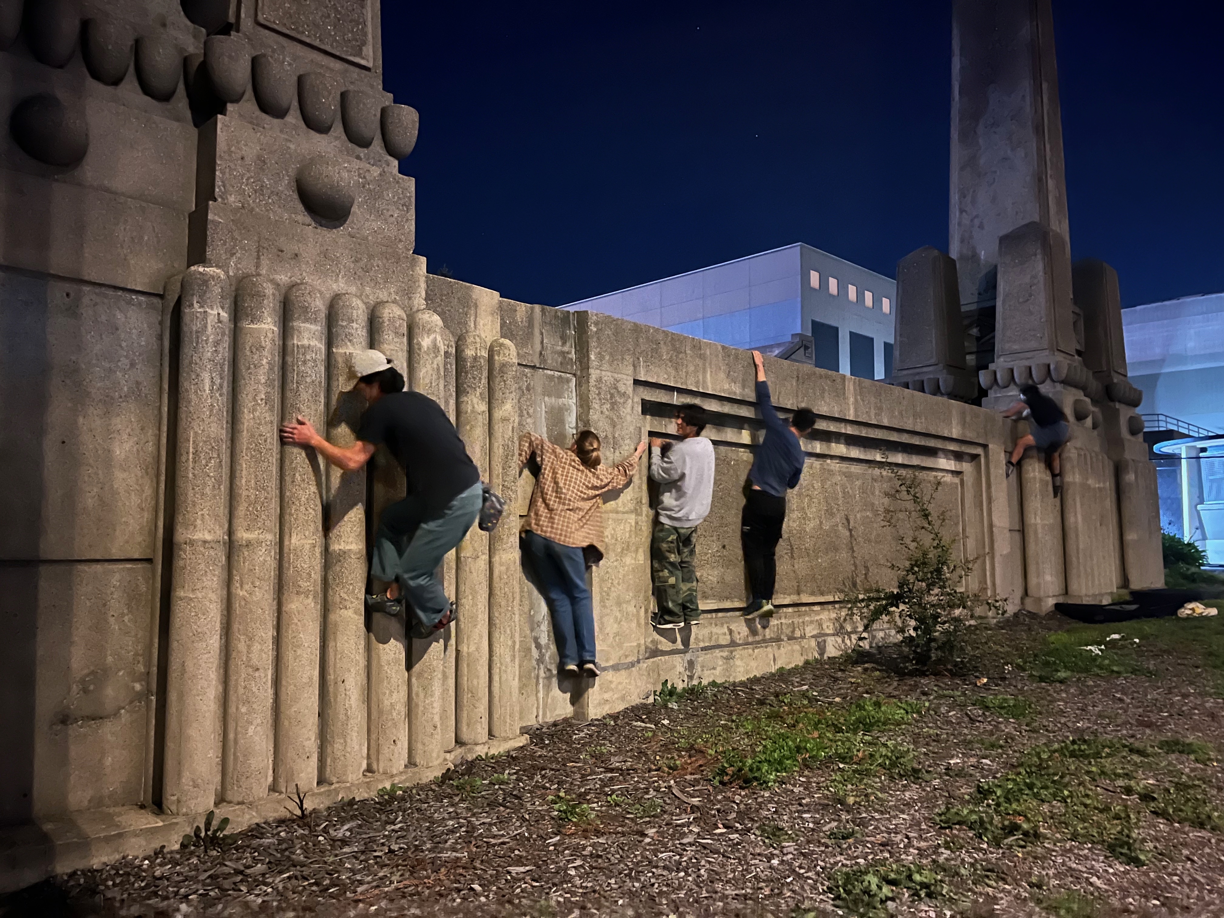 People climbing on campus architecture